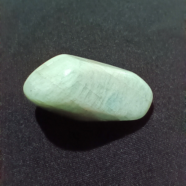Amazonite Healing Crystal, Tumbled, 1 Stone, light bluish stone on black background, 2