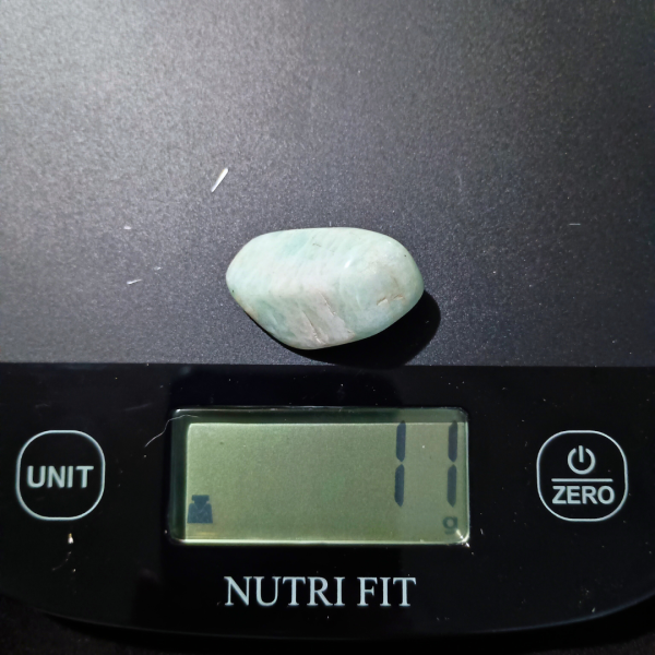 Amazonite Healing Crystal, Tumbled, 1 Stone, light bluish stone on scale, 11 cm