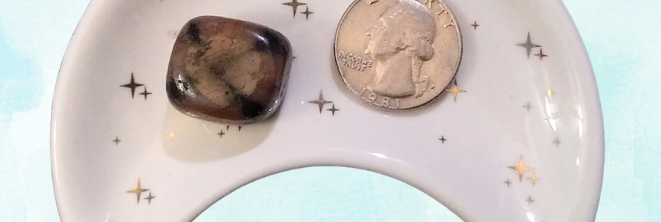 Andalusite Healing Crystal (Chiastolite), Tumbled, 1 Stone in moon-shaped dish on blue backgrround