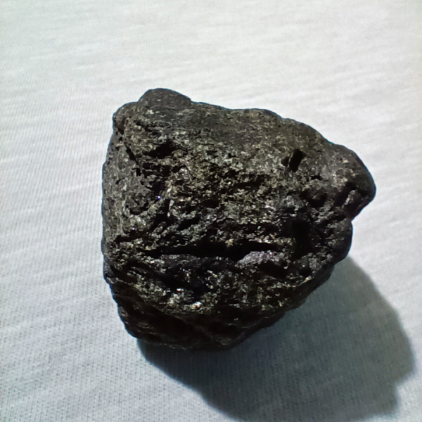 Black Tourmaline Healing Crystal, Raw, 1 Stone on gray background (1)