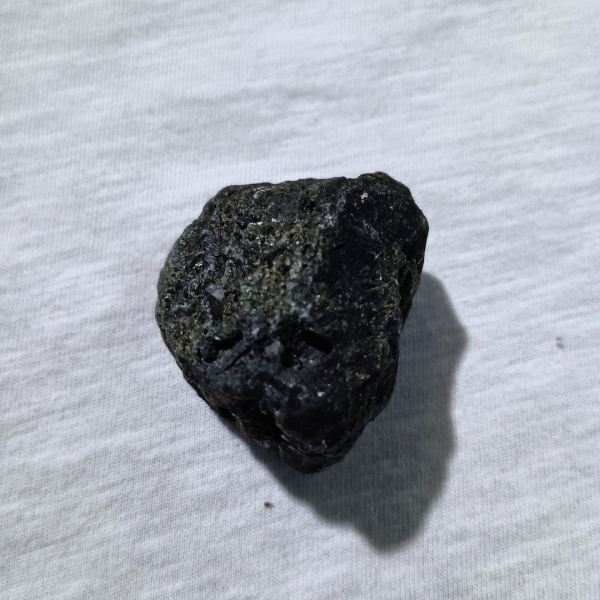 Black Tourmaline Healing Crystal, Raw, 1 Stone on gray background