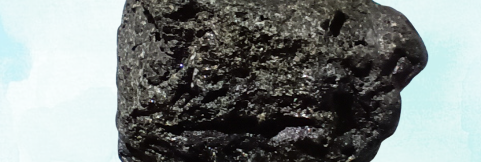 Black Tourmaline Healing Crystal, Raw, 1 Stone on light background