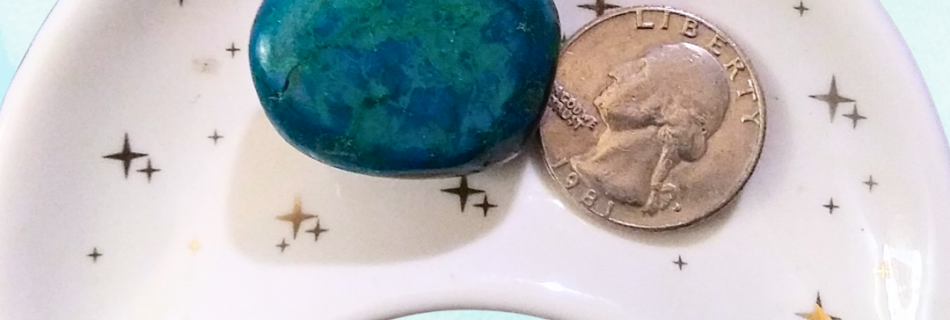 Chrysocolla Healing Crystal, Tumbled, 1 Stone, in moon-shaped dish on light background