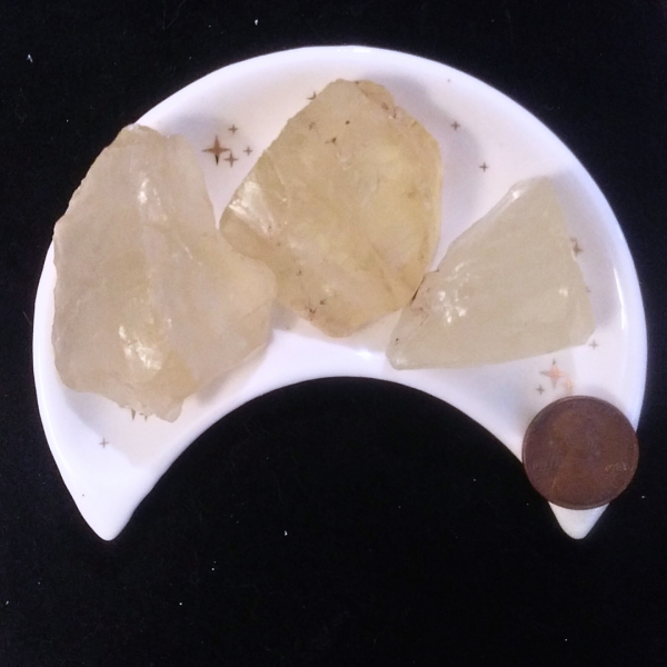 Citrine Healing Crystal, Raw, 1 Stone, 3 stones in moon-shaped dish on a black background