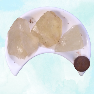 Citrine Healing Crystal, Raw, 1 Stone, 3 stones in moon-shaped dish on a light background