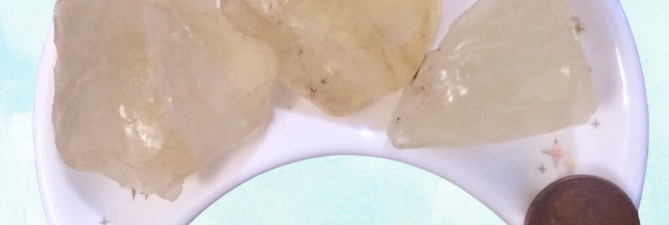 Citrine Healing Crystal, Raw, 1 Stone, 3 stones in moon-shaped dish on a light background