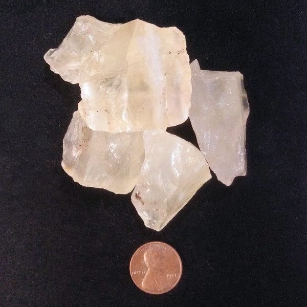 Citrine Healing Crystal, Raw, 1 Stone, pile of stones on a black background