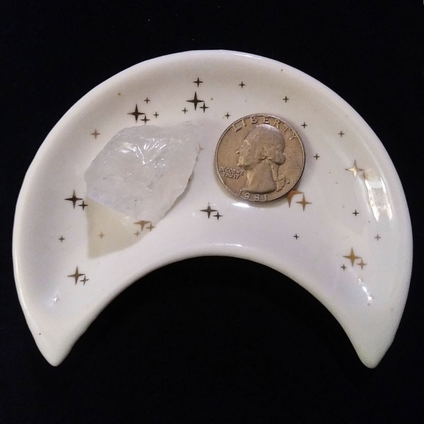 Clear Quartz Healing Crystal, Raw, 1 Stone in moon-shaped dish on black background