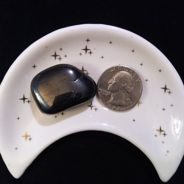 Hematite Healing Crystal, Tumbled, 1 Stone in moon-shaped dish on black background