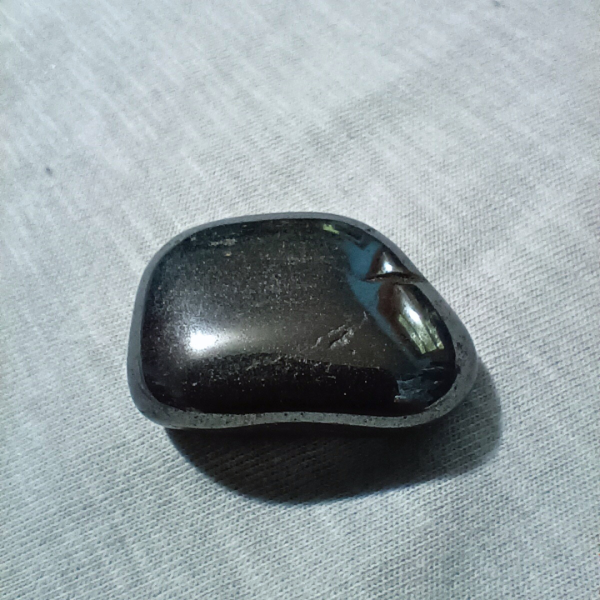 Hematite Healing Crystal, Tumbled, 1 Stone on light background (1)