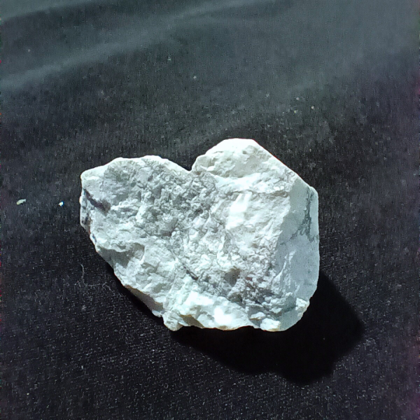 Howlite Healing Crystal, Rough, 1 Stone on black background