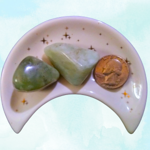 Jade Healing Crystal, Tumbled, 1 Stone, 2 stones in a moon-shaped dish on light background
