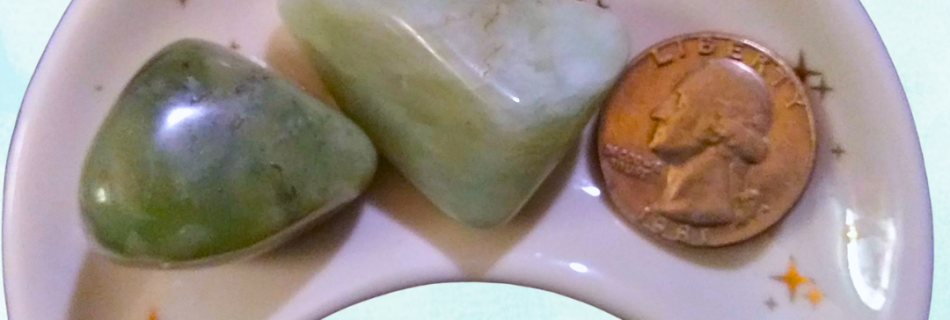 Jade Healing Crystal, Tumbled, 1 Stone, 2 stones in a moon-shaped dish on light background