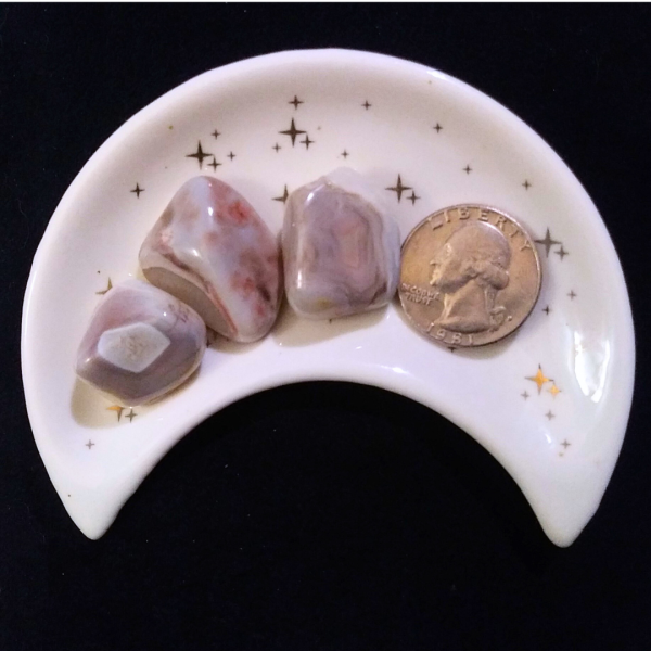 Pink Banded Agate Healing Crystal, Tumbled, 1 Stone, 3 stones in moon-shaped dish on black background