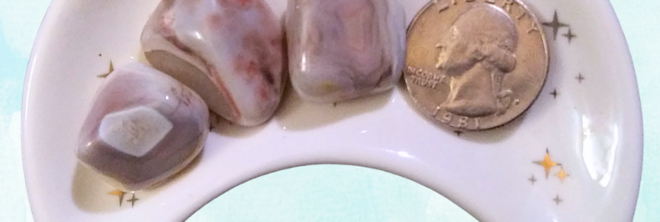 Pink Banded Agate Healing Crystal, Tumbled, 1 Stone, 3 stones in moon-shaped dish on light background