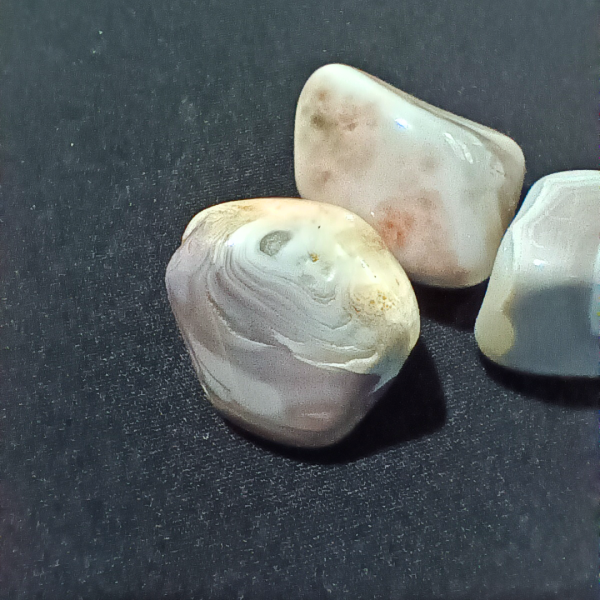 Pink Banded Agate Healing Crystal, Tumbled, 1 Stone on black background (1)