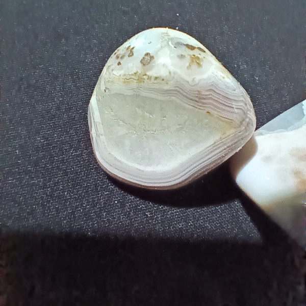 Pink Banded Agate Healing Crystal, Tumbled, 1 Stone on black background