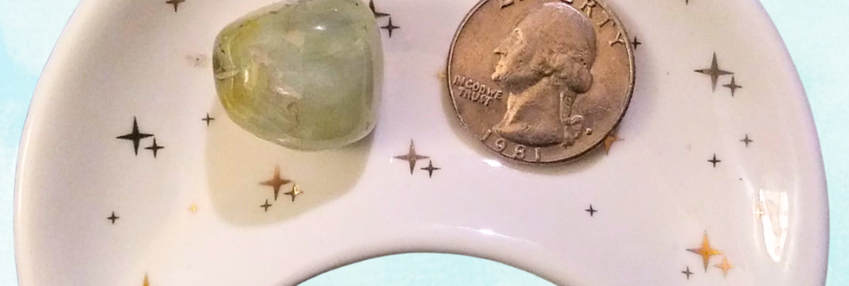 Prehnite Healing Crystal, Tumbled, 1 Stone in moon-shaped dish on light background