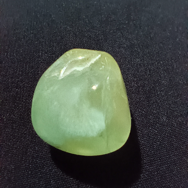 Prehnite Healing Crystal, Tumbled, 1 Stone on black background