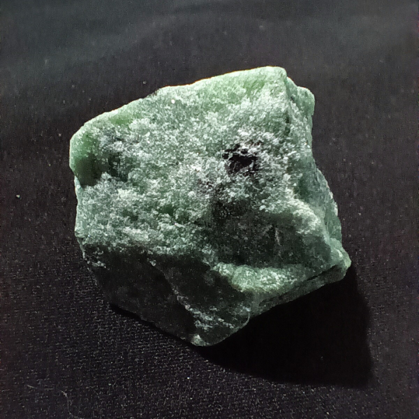 Ruby Zoisite Healing Crystal, Raw, 1 Stone on black background