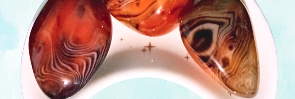 Silk Agate Healing Crystal, 3 stones in a moon-shaped dish on light background