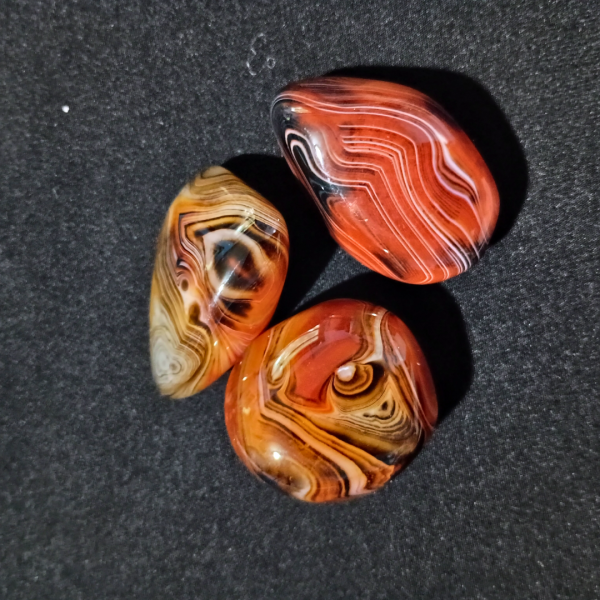 Silk Agate Healing Crystal, 3 stones on black background
