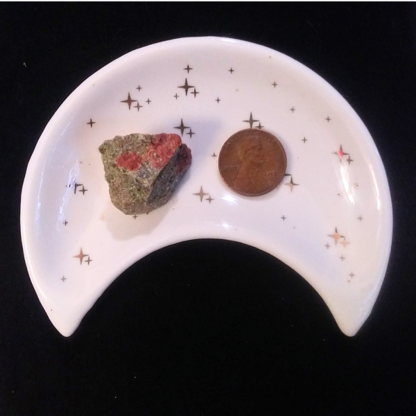 Unakite Healing Crystal, Raw, 1 Stone in moon-shaped dish on black background