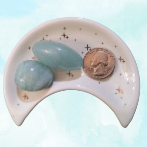 Aquamarine Healing Crystal, Tumbled, 1 Stone, stones in moon-shaped dish on light blue background