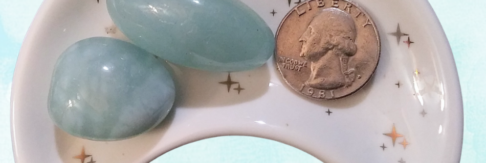 Aquamarine Healing Crystal, Tumbled, 1 Stone, stones in moon-shaped dish on light blue background