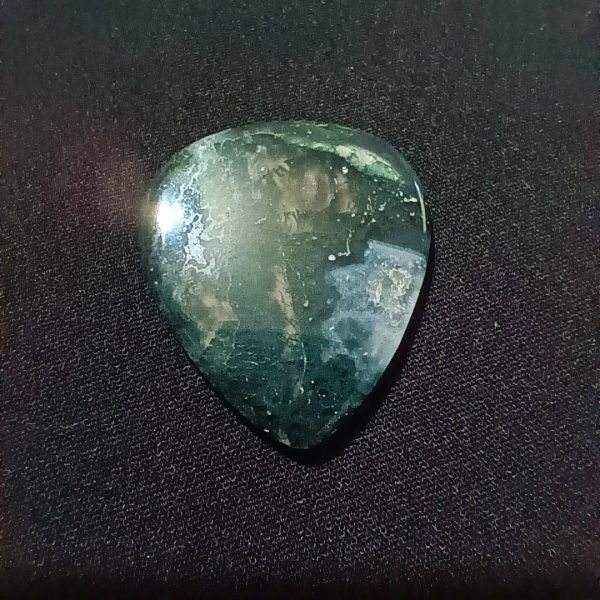 Moss Agate Healing Crystal, Guitar Pick, 1 Pick on black background