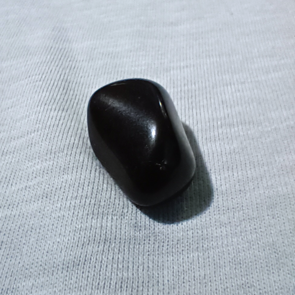 Obsidian Healing Crystal, Tumbled, 1 Stone on light background