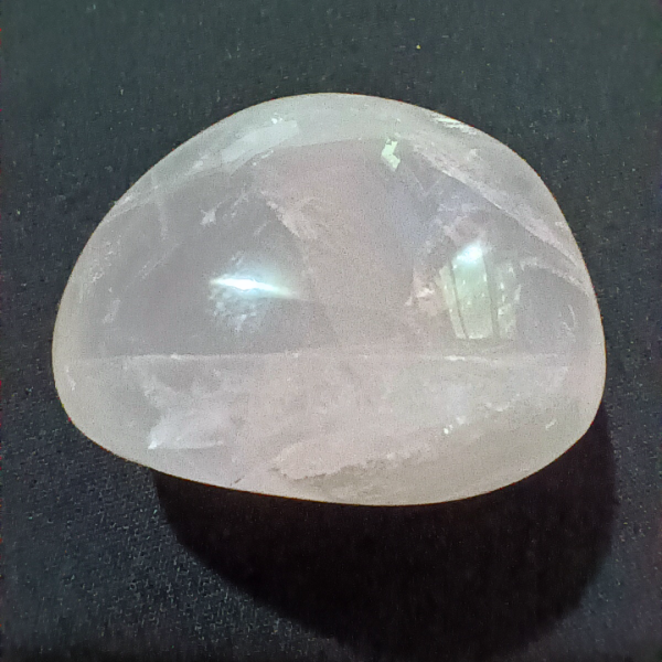 Rose Quartz Healing Crystal, Tumbled, 1 Stone on black background