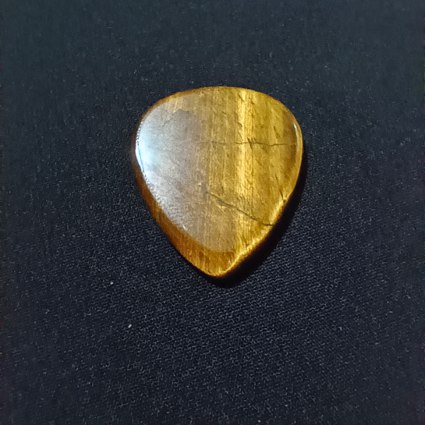 Tigers Eye Healing Crystal, Guitar Pick, 1 Pick on black background