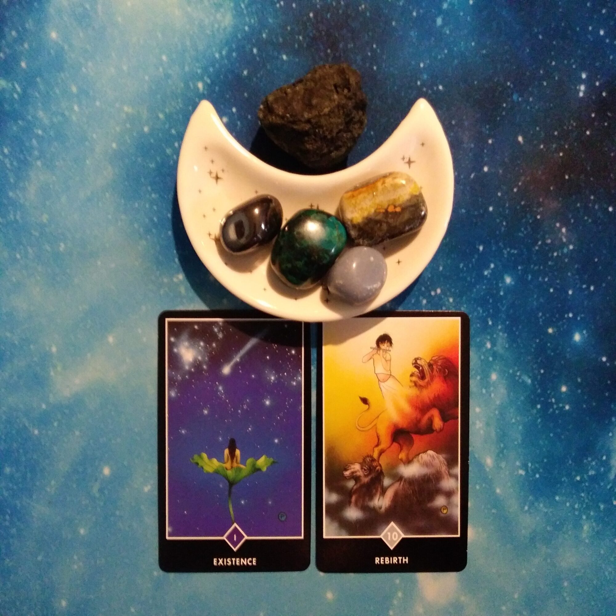 2 Osho Zen tarot cards and crystals on a starry blue background