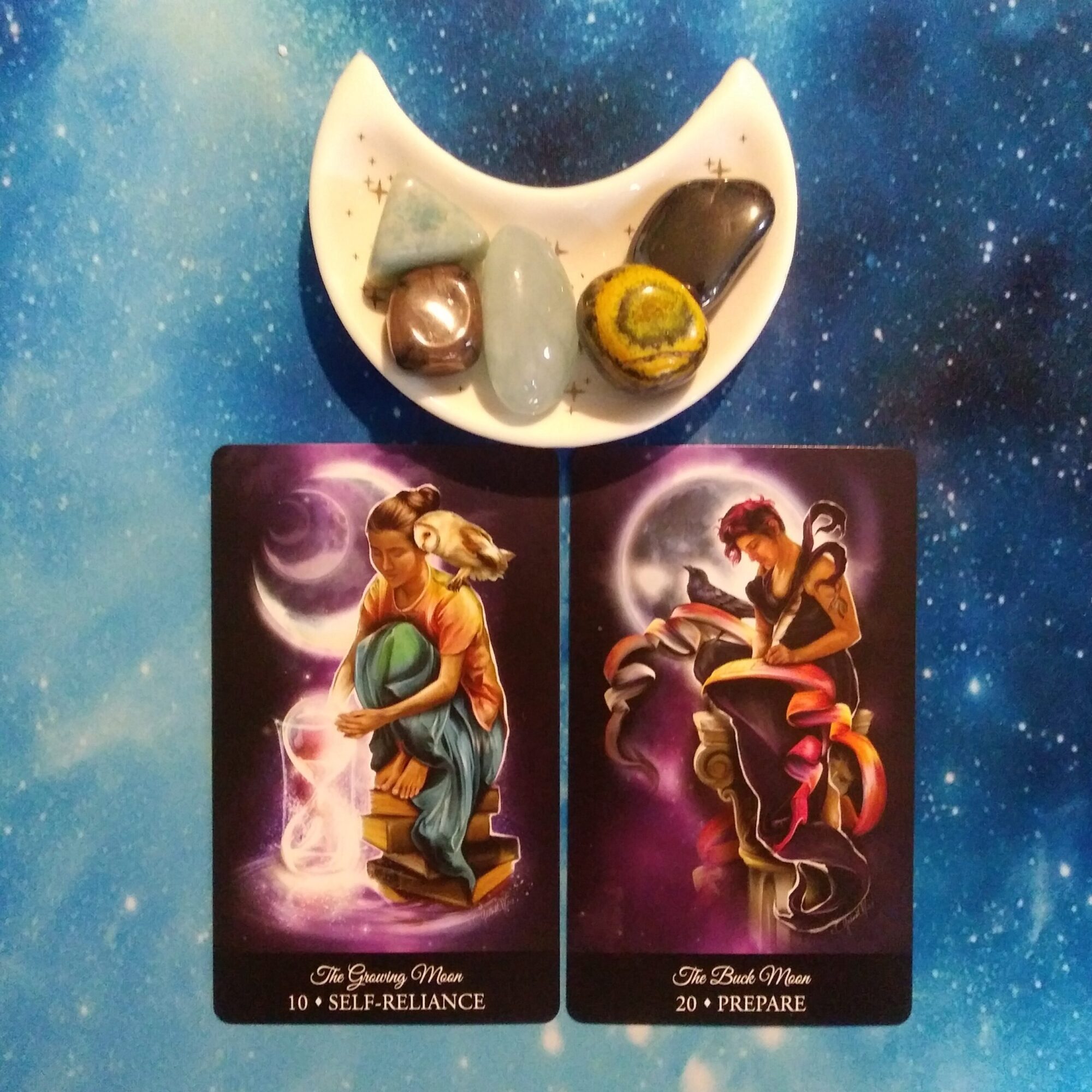 2 Witching Hour Oracle cards and crystals on a blue, starry background
