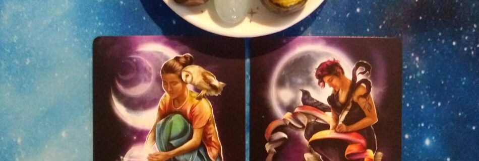 2 Witching Hour Oracle cards and crystals on a blue, starry background