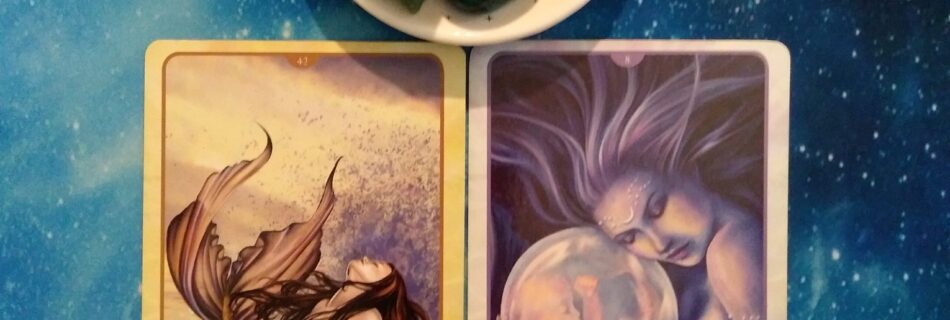 2 Oracle of the Mermaids cards and crystals on a starry blue background