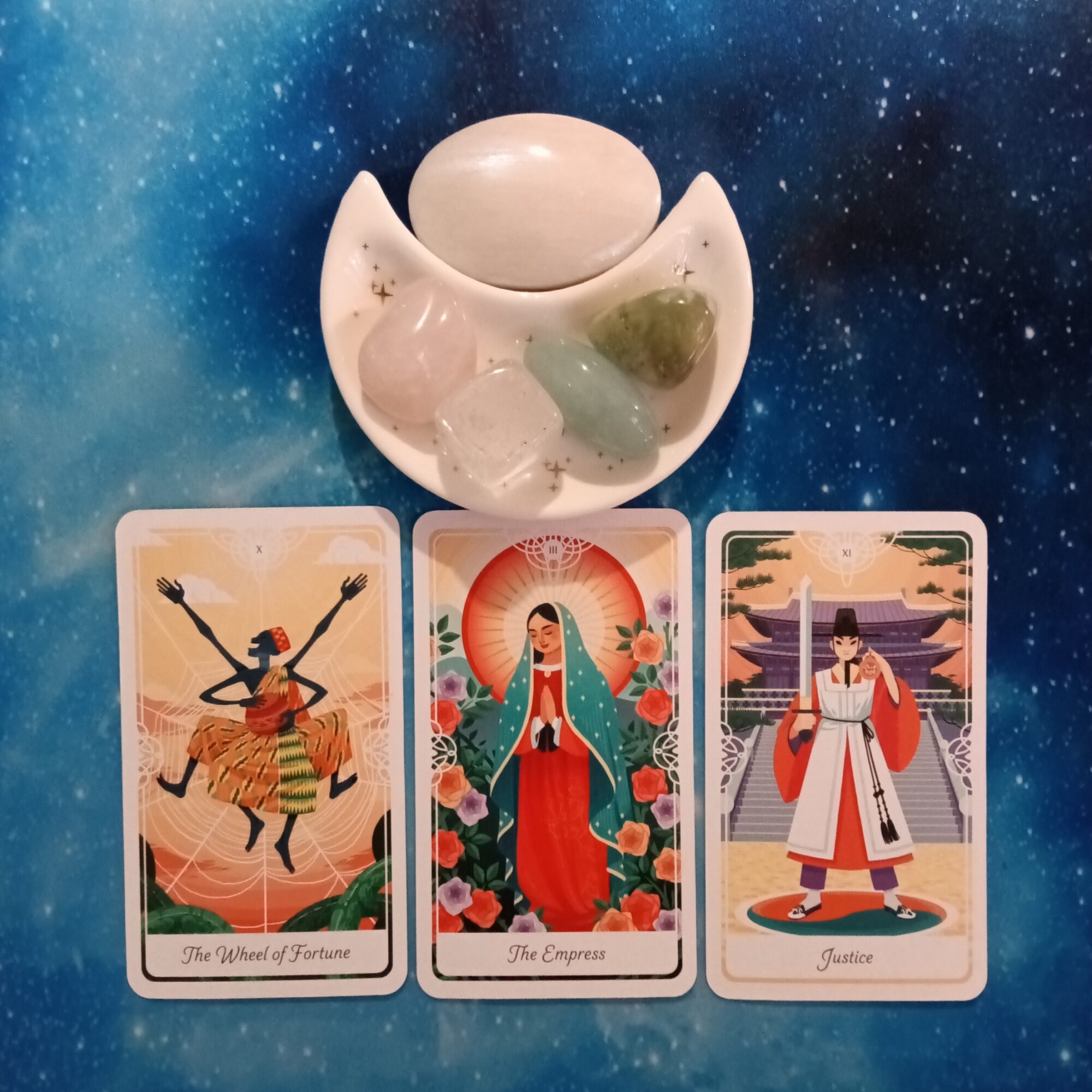 A Pleasant Surprise ~ A Message From the Universe, 3 Tarot of the Divine cards and crystals on a starry blue background