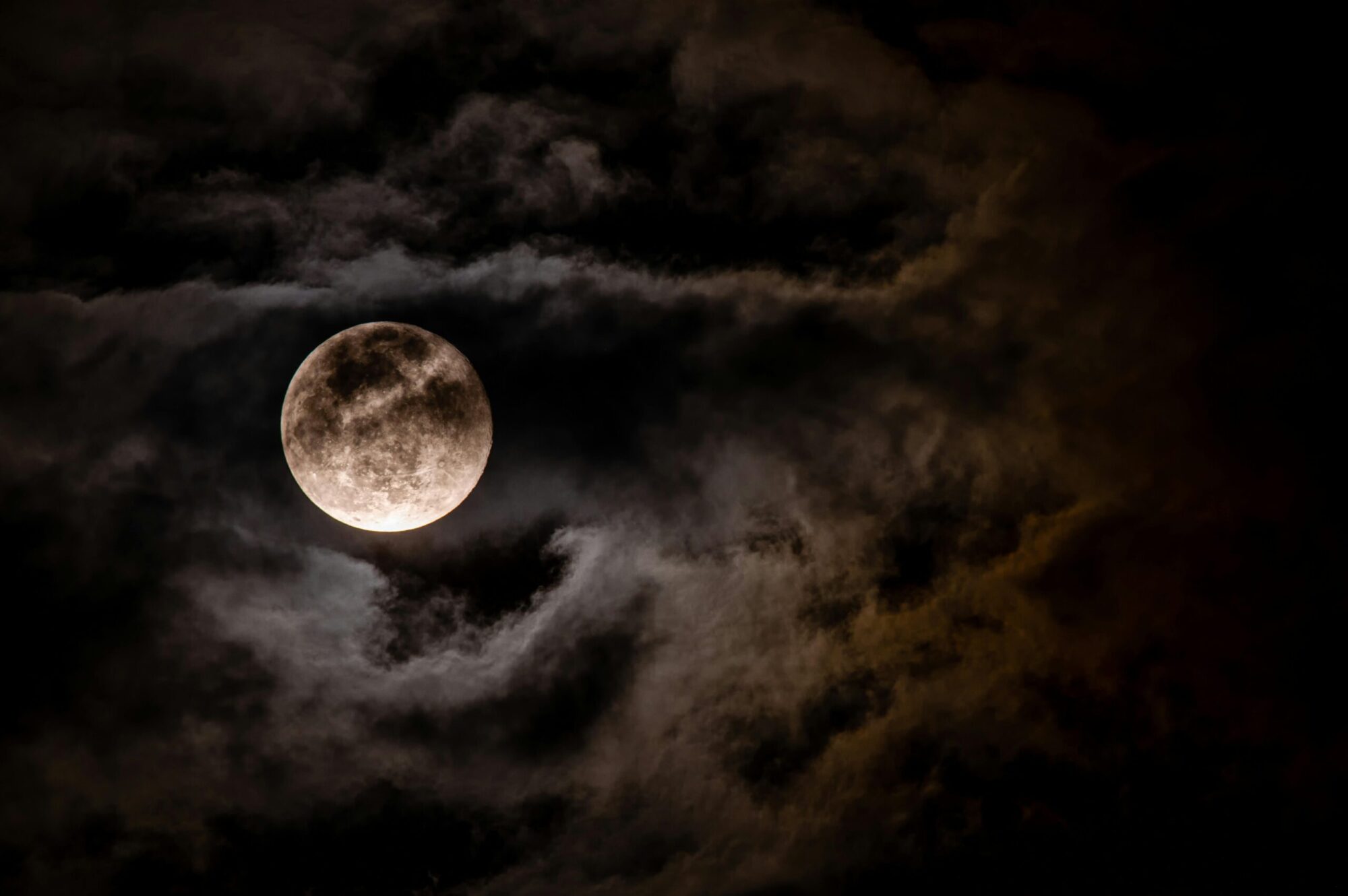 Full Moon Tarotscope for December 2024 - Image of a full moon in a partially cloudy sky