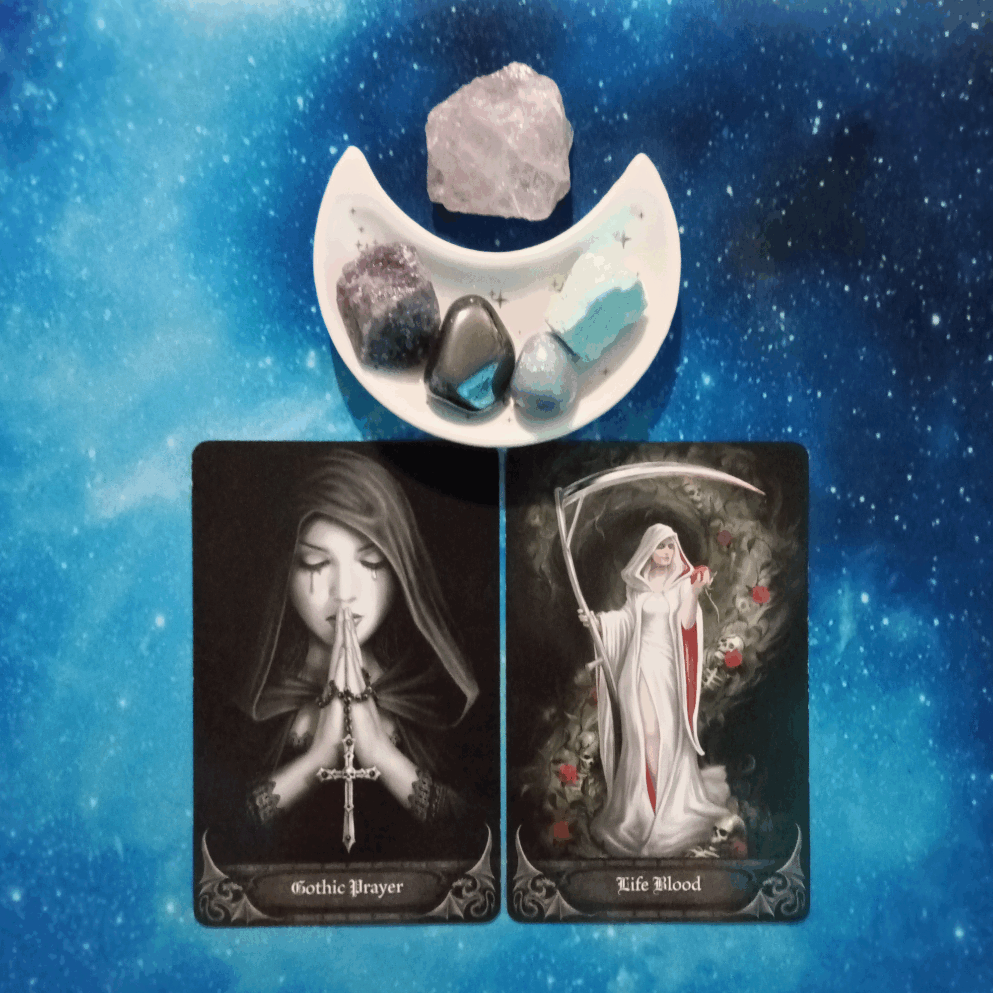 Your Difficulties Are Temporary ~ A Message From the Universe, 2 Anne Stokes Gothic Oracle cards and crystals on a starry blue background
