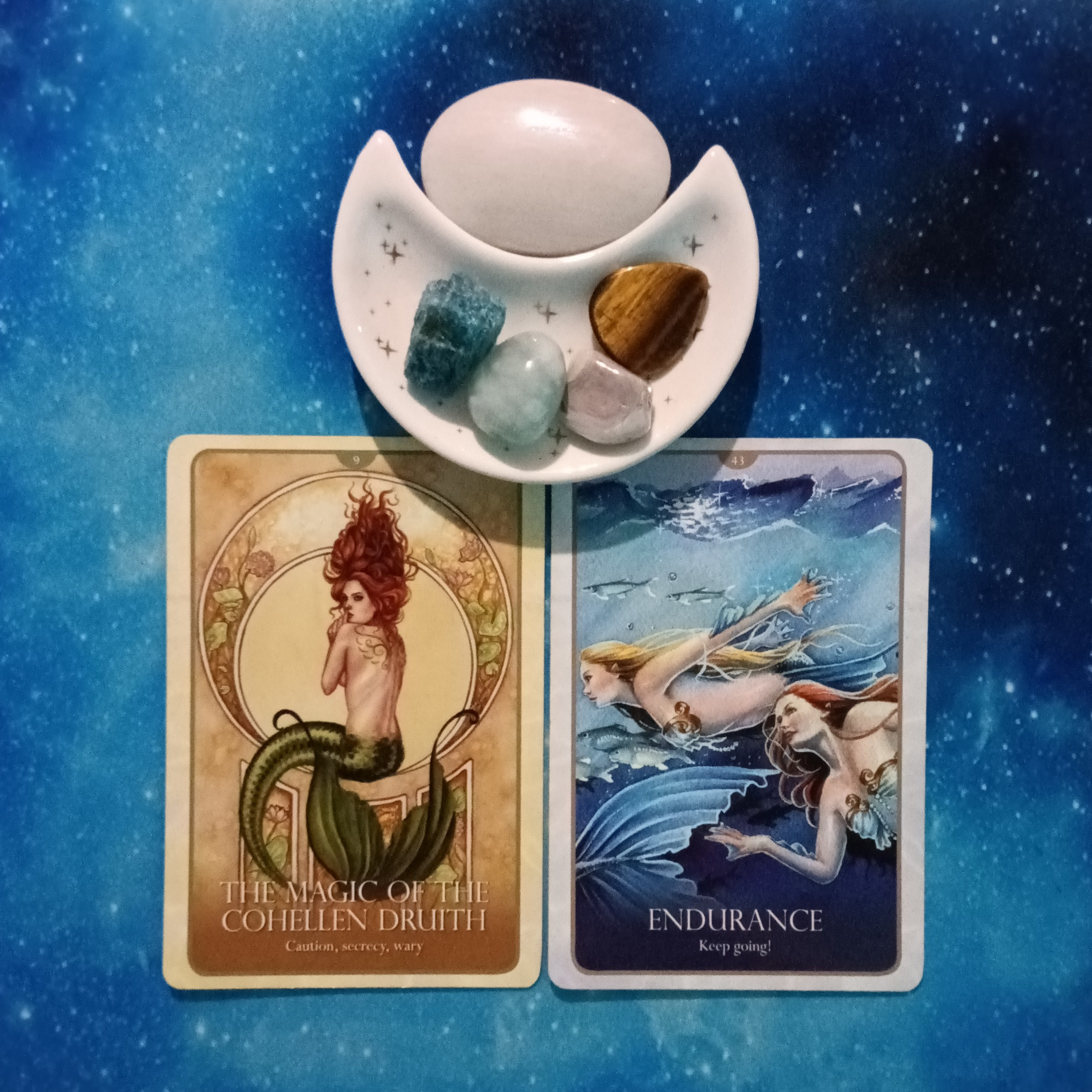 Just Keep Swimming! A Message From the Universe, 2 Faeries Oracle cards and crystals on a starry blue background