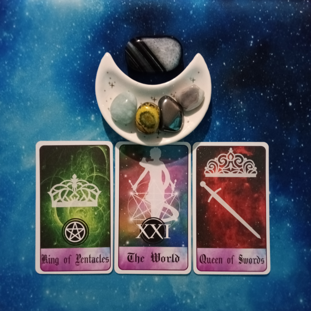 Closing Out A Big Chapter ~ A Message From the Universe, 3 Celestial Tarot cards and crystals on a starry blue background