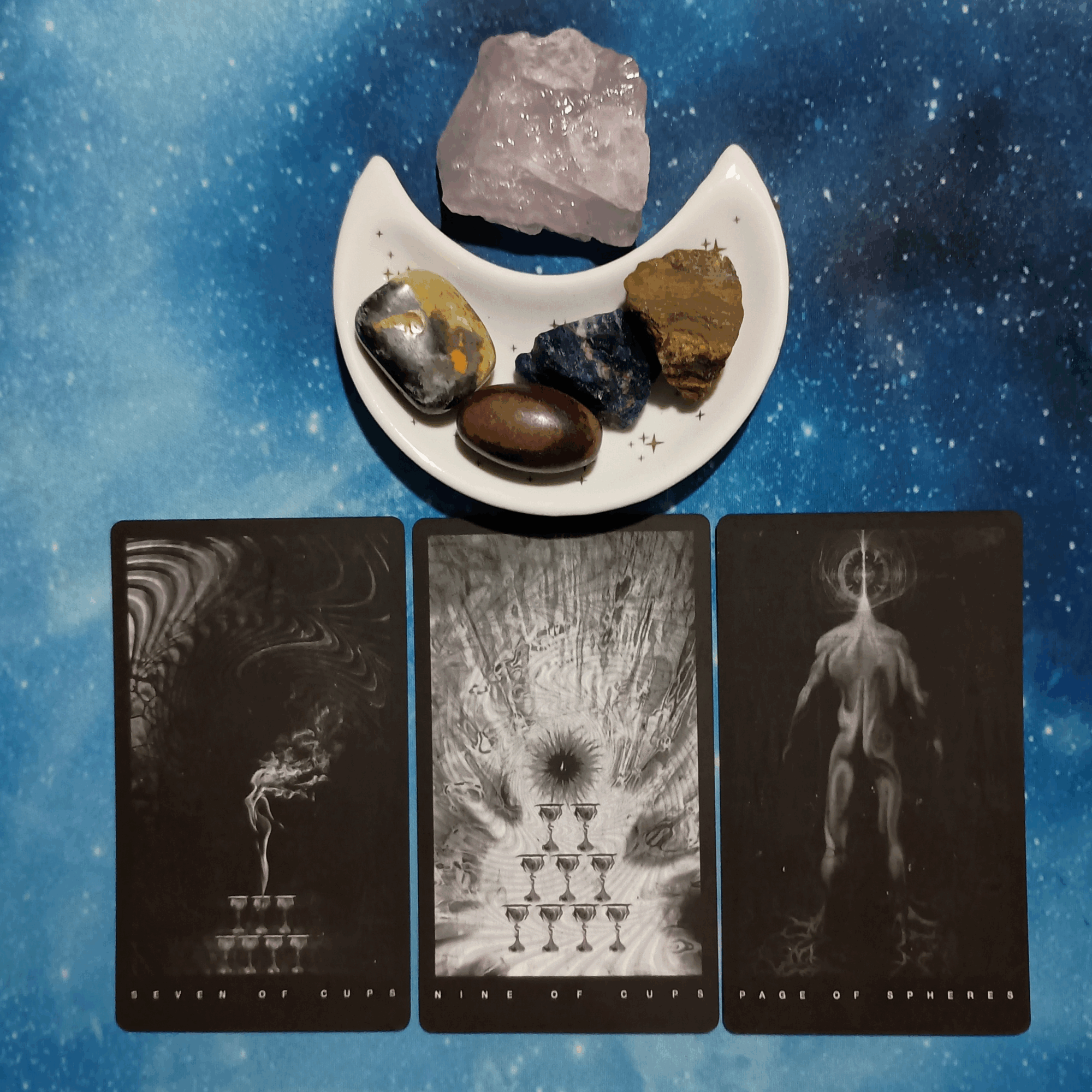 Abundance All Around You ~ A Message From the Universe, Black Tarot cards and crystals on a starry blue background