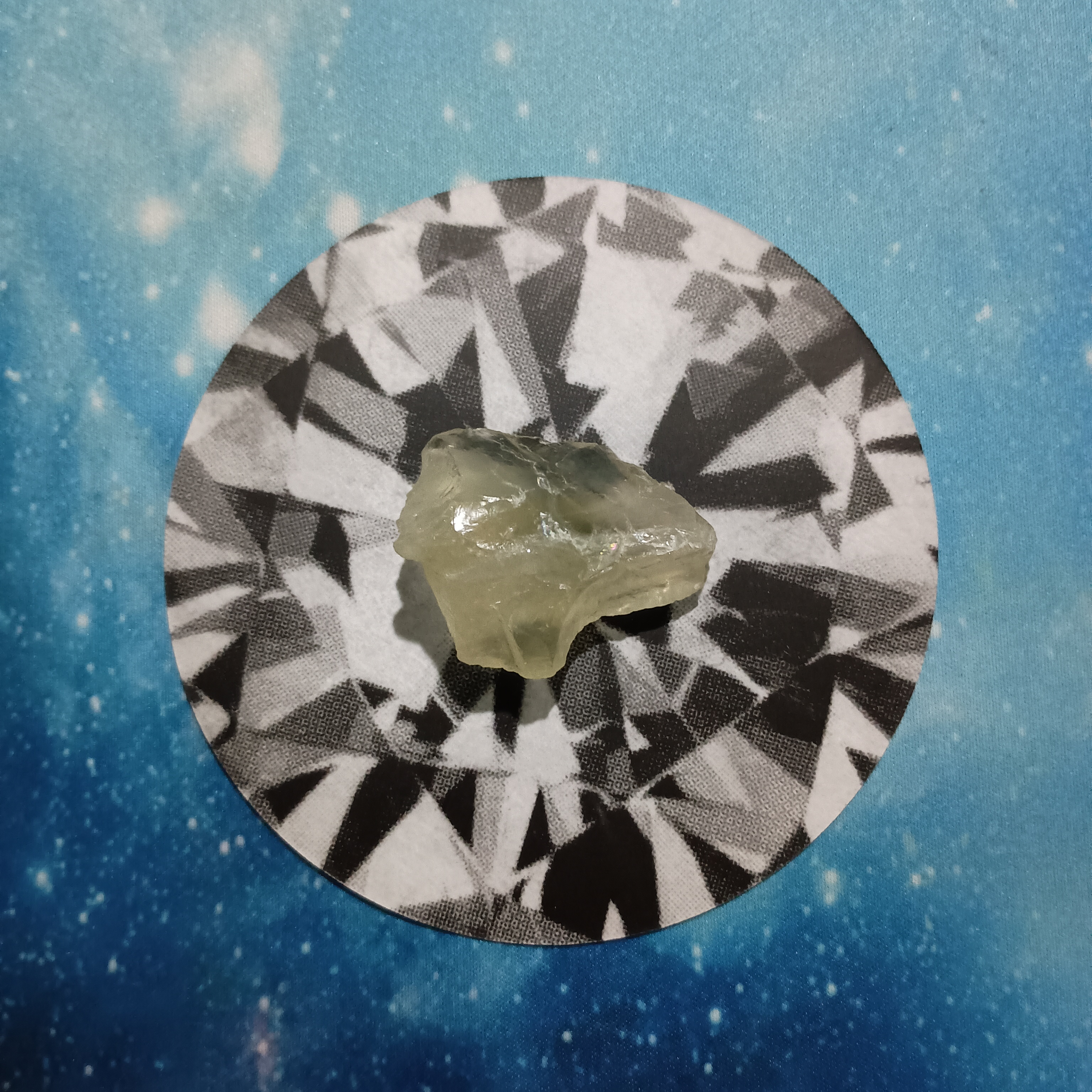 New Moon Pick-a-Card Tarot Reading for June 2025, pile 2 - Silk Agate stone (orange and brown) and an oracle card, face down, on a starry blue background