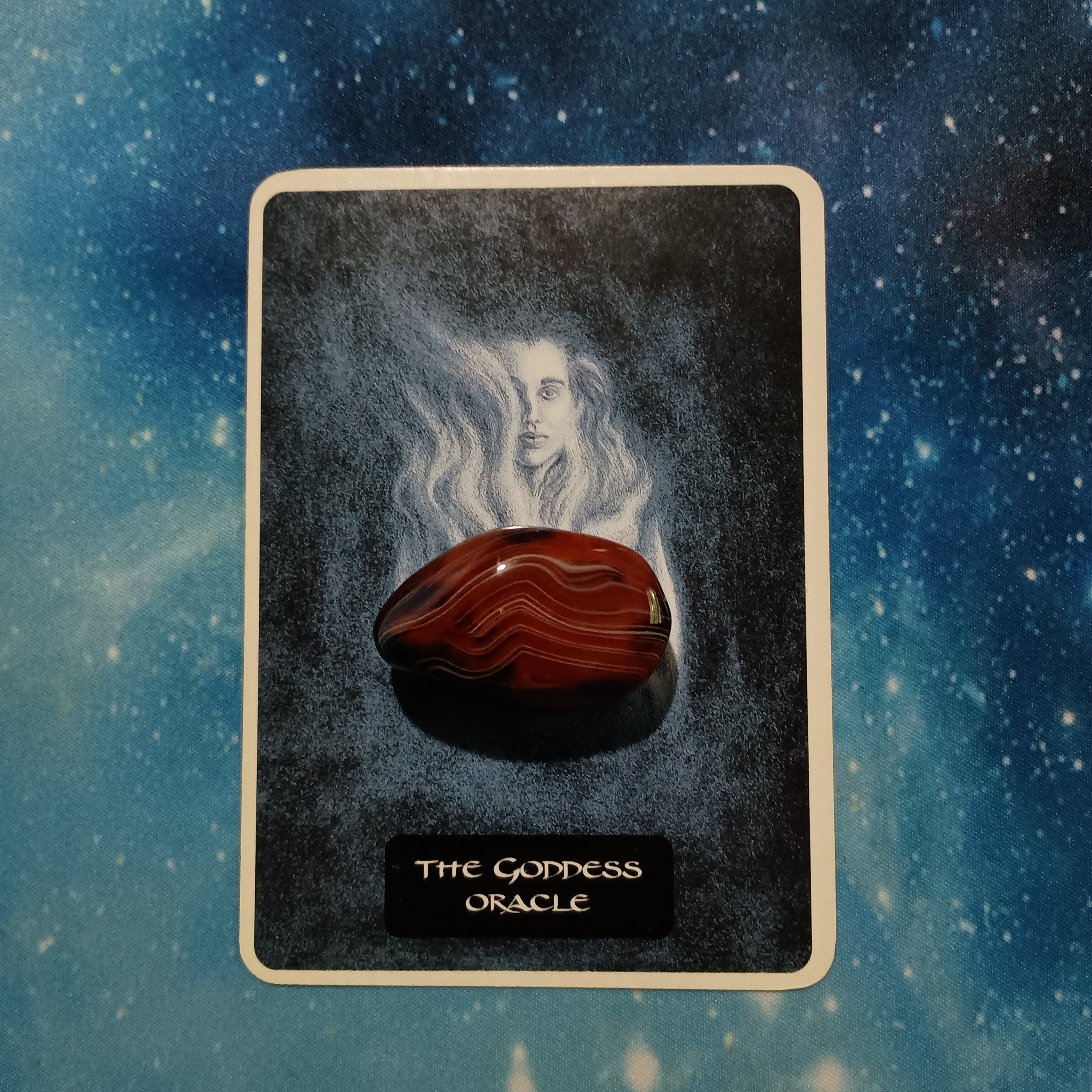 Full Moon Pick-a-Card Tarot Reading for July 2025, Pile 2, Silk Agate crystal (orange and brown) on 1 oracle card, face down