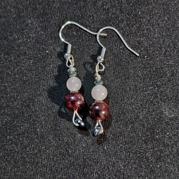 Cosmic Connection Garnet & Rose Quartz Earrings, flat lay, black BKG
