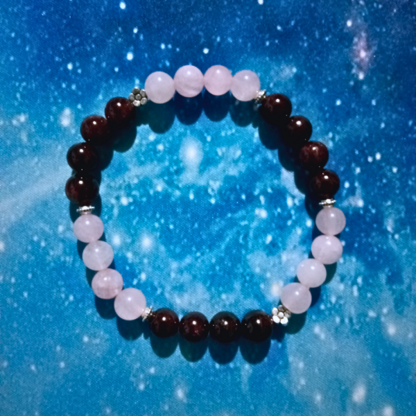 Cosmic Connection Rose Quartz & Garnet Bracelet for Unconditional Love, top view, blue bkg