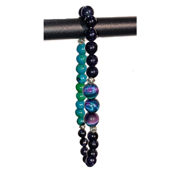 Cosmic Spark: Blue Goldstone, Malachite, Azurite, & Tiger's Eye Bracelet for Creation & Manifestation, hanging from display, white background