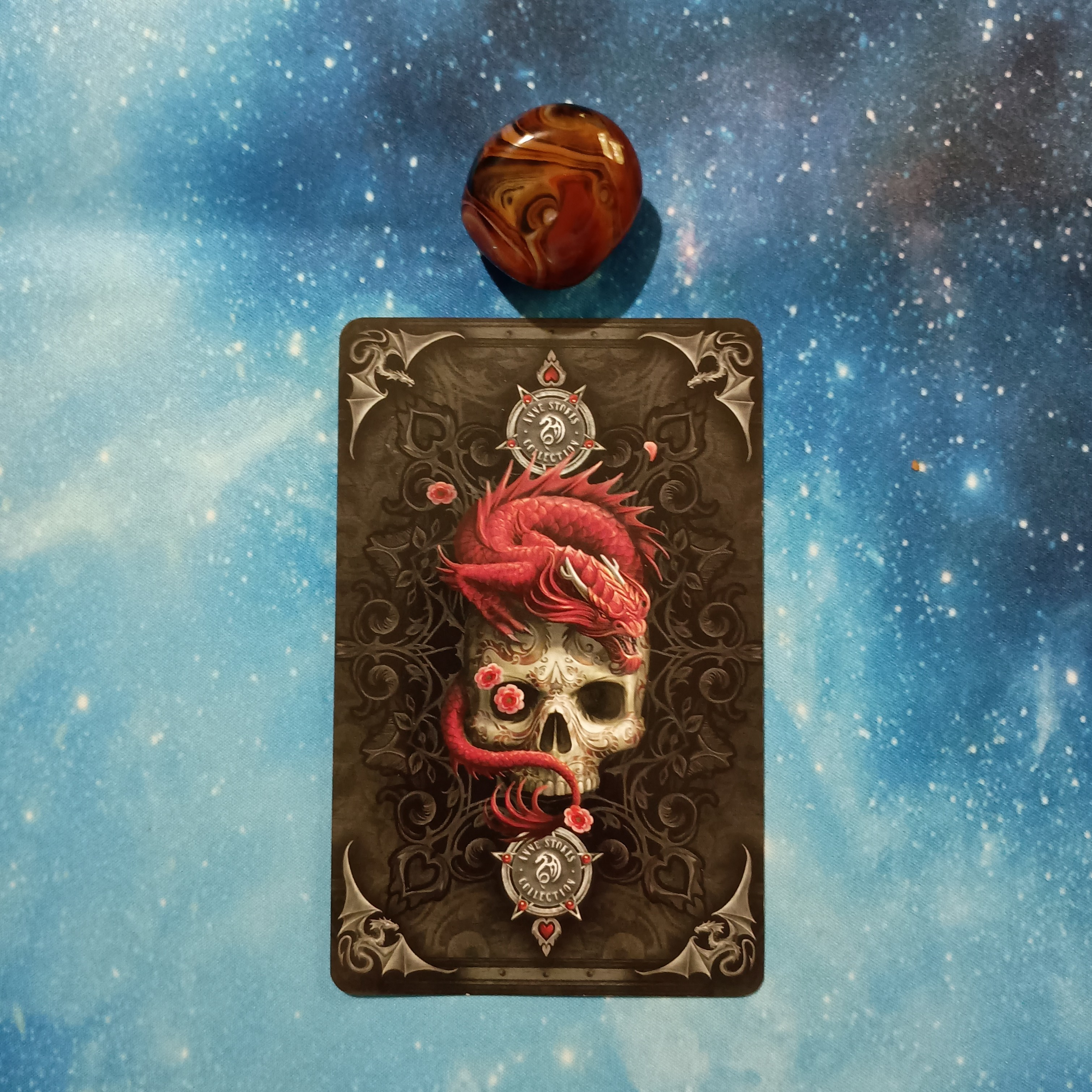 Full Moon Magic: Your August 2025 Pick-a-Card Tarot Reading, Pile 2, Silk Agate crystal on a starry blue background, and 1 oracle card, face down
