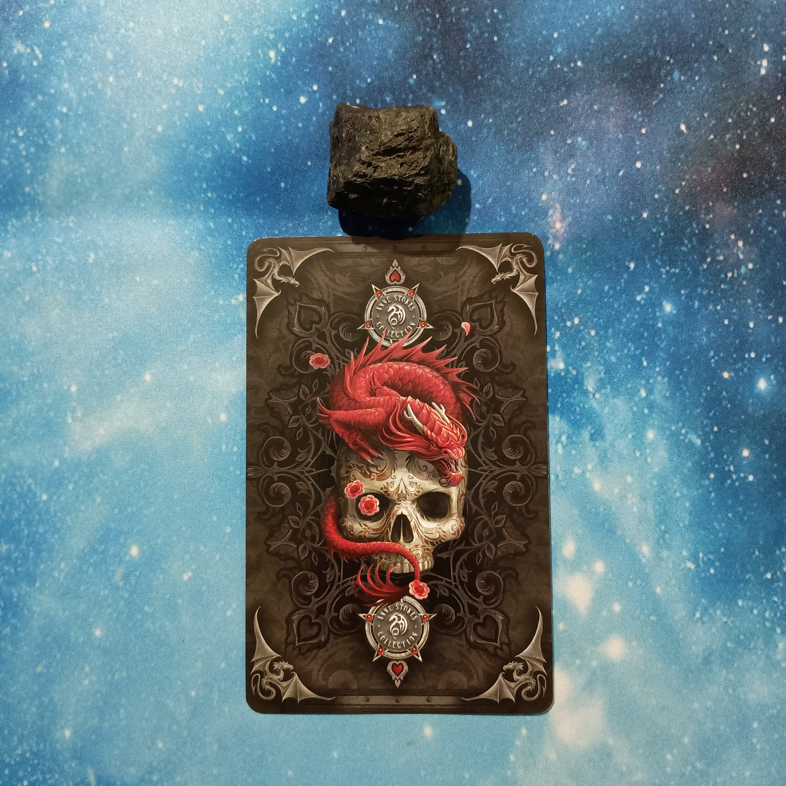 Full Moon Magic: Your August 2025 Pick-a-Card Tarot Reading, Pile 3, Black Tourmaline crystal on a starry blue background, and 1 oracle card, face down